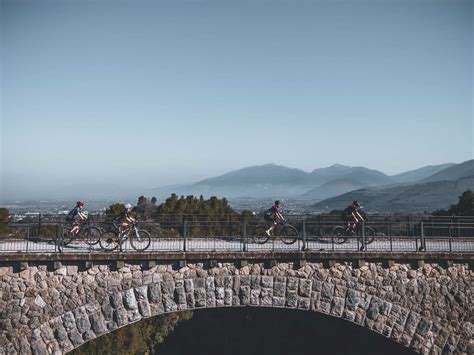 Ciclista su un ponte con una bicicletta al seguito