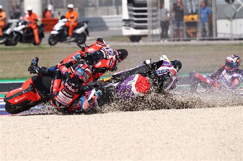 MotoGP rider helping another rider after a crash