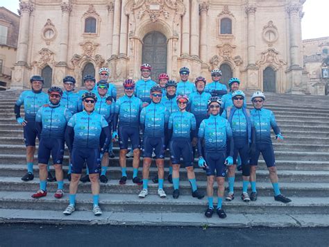 Un gruppo di ciclisti sorride dopo una gara di beneficenza